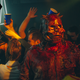 Skull: The Mask's blood-drenched demon in a skull mask roams through a dance party.